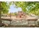 Community playground with various play structures, swings, and benches for Gathering enjoyment at 1140 Devonshire Ct, Lafayette, CO 80026
