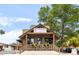Charming exterior view of 'The Read Queen' bookstore and cafe with a rustic wooden design and porch seating at 1140 Devonshire Ct, Lafayette, CO 80026