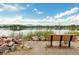 Scenic lake view with a bench, mountains in the distance, and a serene waterfront setting at 1140 Devonshire Ct, Lafayette, CO 80026
