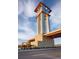 Close up of The Highlands clock tower with stone base and copper accents at 3331 N Buchanan Way, Aurora, CO 80019