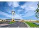Wide shot of the community entrance, showcasing the clock tower and 'The Aurora Highlands' sign at 3331 N Buchanan Way, Aurora, CO 80019