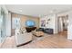 Comfortable living room with wood floors, neutral decor, and a wall-mounted TV at 3331 N Buchanan Way, Aurora, CO 80019