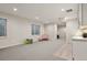 Open finished basement area featuring a modern wet bar and play space at 11151 W 53Rd Dr, Wheat Ridge, CO 80033