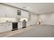 Modern basement bar area with white cabinets, wine storage, and stainless steel appliances at 11151 W 53Rd Dr, Wheat Ridge, CO 80033