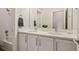 Bright bathroom featuring a double vanity with modern fixtures and a shower at 11151 W 53Rd Dr, Wheat Ridge, CO 80033