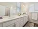 Bright bathroom with double vanity, modern fixtures, and a glass-enclosed shower at 11151 W 53Rd Dr, Wheat Ridge, CO 80033