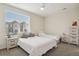 Bright bedroom with two twin beds, a ceiling fan, and a large window with blinds at 11151 W 53Rd Dr, Wheat Ridge, CO 80033