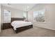 Serene bedroom with a dark wood furniture set, soft carpet, and ample natural light at 11151 W 53Rd Dr, Wheat Ridge, CO 80033