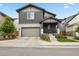 Two-story home with gray siding, brick accents, a well-kept lawn, and an attached two-car garage at 11151 W 53Rd Dr, Wheat Ridge, CO 80033
