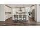 Modern kitchen with white cabinets, stainless steel appliances, a kitchen island, and gray backsplash at 11151 W 53Rd Dr, Wheat Ridge, CO 80033