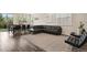 Open-concept living room with wood floors, a large leather sectional, and a view of the backyard at 11151 W 53Rd Dr, Wheat Ridge, CO 80033