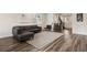 Spacious living room with hardwood floors, leather furniture, and natural light at 11151 W 53Rd Dr, Wheat Ridge, CO 80033