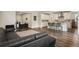 Open concept living space featuring a modern kitchen with white cabinets and a spacious living area at 11151 W 53Rd Dr, Wheat Ridge, CO 80033