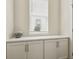 Bright storage area featuring white cabinets, under a window with closed blinds at 11151 W 53Rd Dr, Wheat Ridge, CO 80033