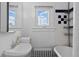 Bright bathroom with a pedestal sink, window, and vintage tiled walls at 1136 N Logan St # 8, Denver, CO 80203