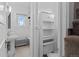 Compact bathroom featuring a pedestal sink, toilet, and storage cabinet with a bright window at 1136 N Logan St # 8, Denver, CO 80203