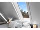 Bright attic bedroom featuring a skyline view through a large skylight window at 1136 N Logan St # 8, Denver, CO 80203