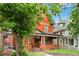 Classic brick house with inviting front porch and lush greenery at 1136 N Logan St # 8, Denver, CO 80203