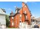 Rear exterior of a red brick home featuring a fire escape at 1136 N Logan St # 8, Denver, CO 80203