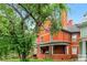 Stately brick home with mature trees, covered porch, and classic architectural details at 1136 N Logan St # 8, Denver, CO 80203