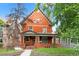 Charming red brick two-story home featuring a welcoming front porch and classic architectural details at 1136 N Logan St # 8, Denver, CO 80203