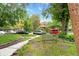 Image of tree-lined street view with walkway, bench, and nearby parking at 1136 N Logan St # 8, Denver, CO 80203