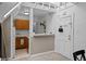 Compact kitchen featuring wood cabinets, tiled floors, and a pass-through to the dining area at 1136 N Logan St # 8, Denver, CO 80203