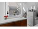 Galley kitchen with wood cabinets, a tiled backsplash, and views to living area at 1136 N Logan St # 8, Denver, CO 80203