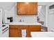 Close-up view of the kitchen area featuring wood cabinets and a tiled backsplash at 1136 N Logan St # 8, Denver, CO 80203