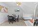 Relaxing living room with a white sofa, dining table, vintage ceiling fan and a TV on the wall at 1136 N Logan St # 8, Denver, CO 80203