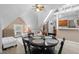 Cozy living room with a dining table, white sofas and a well lit room with a vintage ceiling fan at 1136 N Logan St # 8, Denver, CO 80203