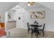 Inviting living room with a white door, dining table, vintage ceiling fan and a painting on the wall at 1136 N Logan St # 8, Denver, CO 80203
