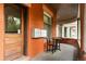 Charming covered porch with brick columns, outdoor seating, and a classic wood door at 1136 N Logan St # 8, Denver, CO 80203