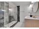 Modern bathroom featuring a walk-in shower with decorative tile, vanity with white countertop, and stylish mirrors at 328 Quay St, Lakewood, CO 80226