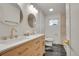 Bright bathroom featuring double sinks with white countertop and natural wood cabinets at 328 Quay St, Lakewood, CO 80226