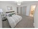 Bright bedroom featuring a comfortable bed, stylish light fixture, and ensuite bathroom at 328 Quay St, Lakewood, CO 80226