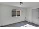 Bright bedroom features gray tile floors, white walls, and a window at 328 Quay St, Lakewood, CO 80226