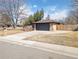 Modern exterior view showcasing a sleek garage door, concrete driveway, and well-maintained front yard at 328 Quay St, Lakewood, CO 80226