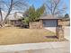 Ranch-style home with brick exterior, a two-car garage, and a stone mailbox in a sunny, grassy front yard at 328 Quay St, Lakewood, CO 80226