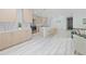 Spacious open-concept kitchen and living room with stainless steel appliances, island seating, and light wood flooring at 328 Quay St, Lakewood, CO 80226