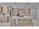 Contemporary kitchen with a quartz-topped island, wooden bar stools, and stainless steel appliances at 328 Quay St, Lakewood, CO 80226