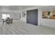 A spacious living room with an open floor plan features stylish floors and a decorative brick wall at 328 Quay St, Lakewood, CO 80226
