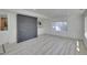 A spacious living room featuring stylish flooring, a brick accent wall, and neutral paint at 328 Quay St, Lakewood, CO 80226