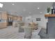 Open concept living room with stainless appliances, kitchen island with seating, and comfortable seating near fireplace at 328 Quay St, Lakewood, CO 80226