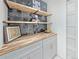 Custom bar with grey cabinets, floating shelves, and butcher block countertop at 328 Quay St, Lakewood, CO 80226