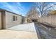 Large patio area with a modern gray exterior, privacy fence, and well-kept landscaping at 328 Quay St, Lakewood, CO 80226