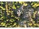 Tranquil aerial view of a home tucked amidst dense foliage and rocky terrain, revealing its secluded setting at 6150 Bluebell Ln, Evergreen, CO 80439