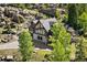 Beautiful home from above with a stone and wood facade, surrounded by trees at 6150 Bluebell Ln, Evergreen, CO 80439