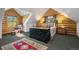 Cozy bedroom features a large dresser, wood paneled walls, and ample natural light at 6150 Bluebell Ln, Evergreen, CO 80439