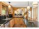 Kitchen with a view to the Living Room, stone fireplace and log staircase at 6150 Bluebell Ln, Evergreen, CO 80439